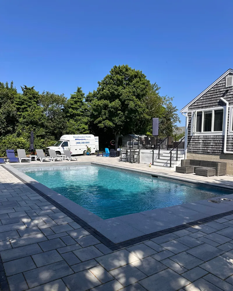 Breakwater Pools service van parked beside a completed Cape Cod pool